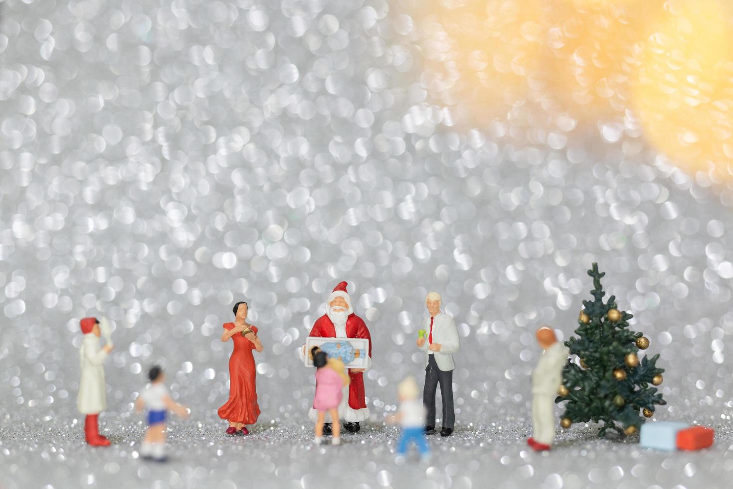 Miniature happy family celebrating Christmas, X-mas and Happy New Year concept photo