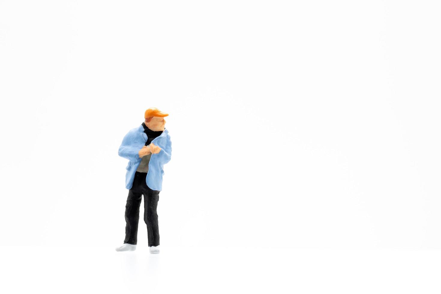 A miniature person standing on a white background photo