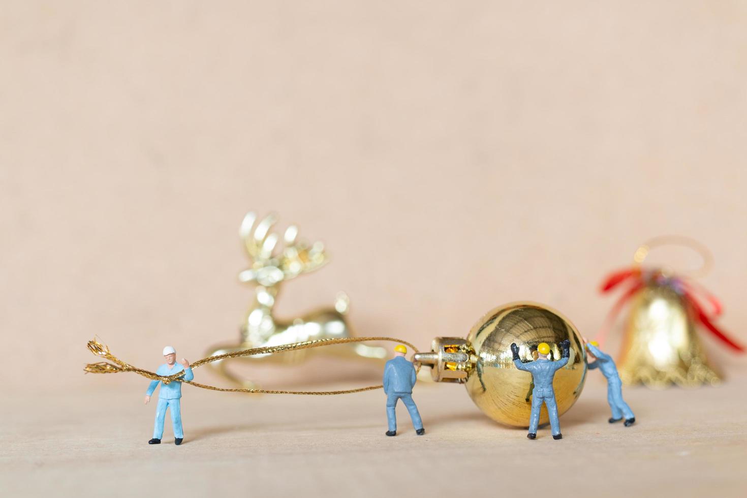 Miniature workers working on Christmas decorations, Christmas and Happy New Year concept photo