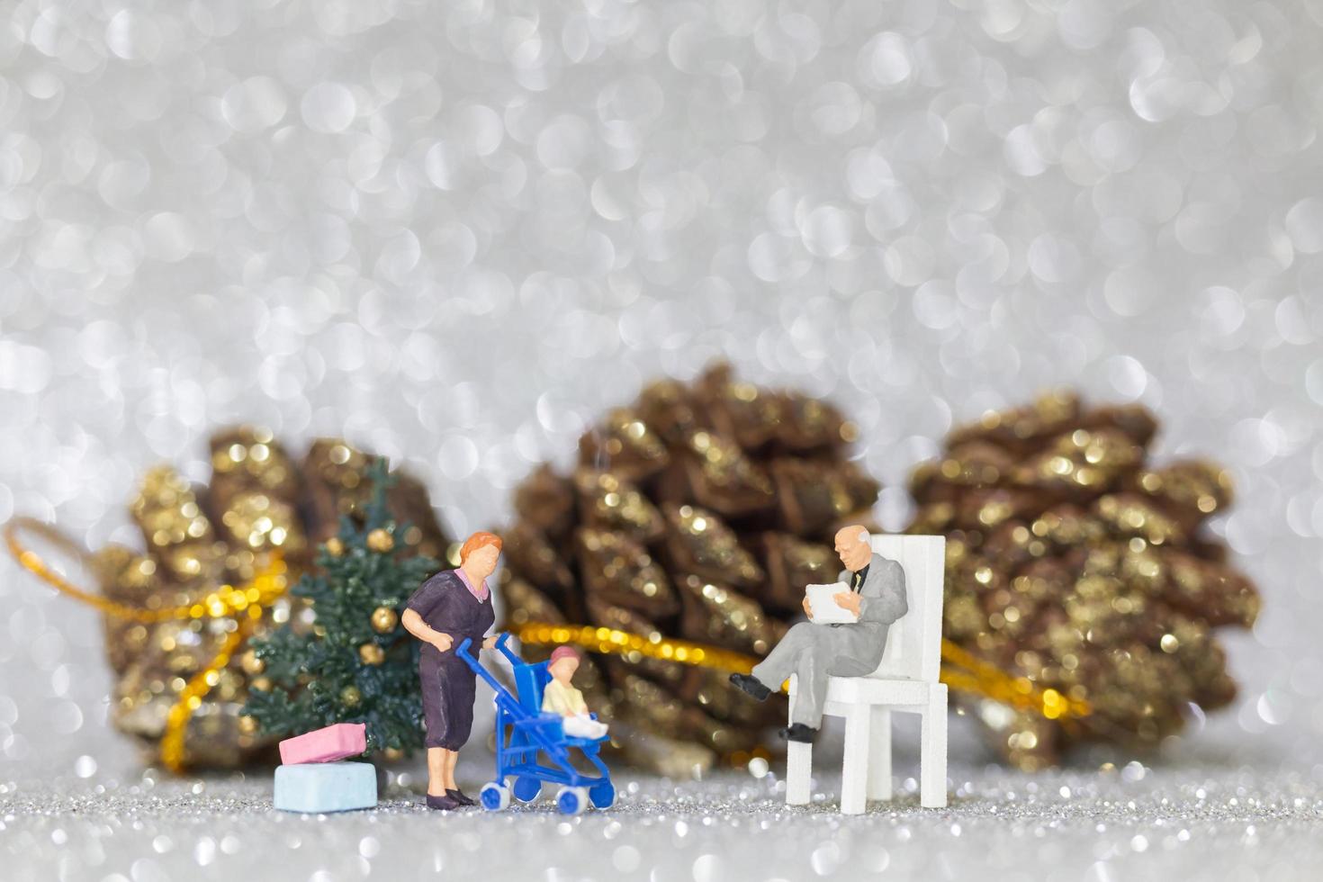 Miniature happy family celebrating Christmas, X-mas and Happy New Year concept photo