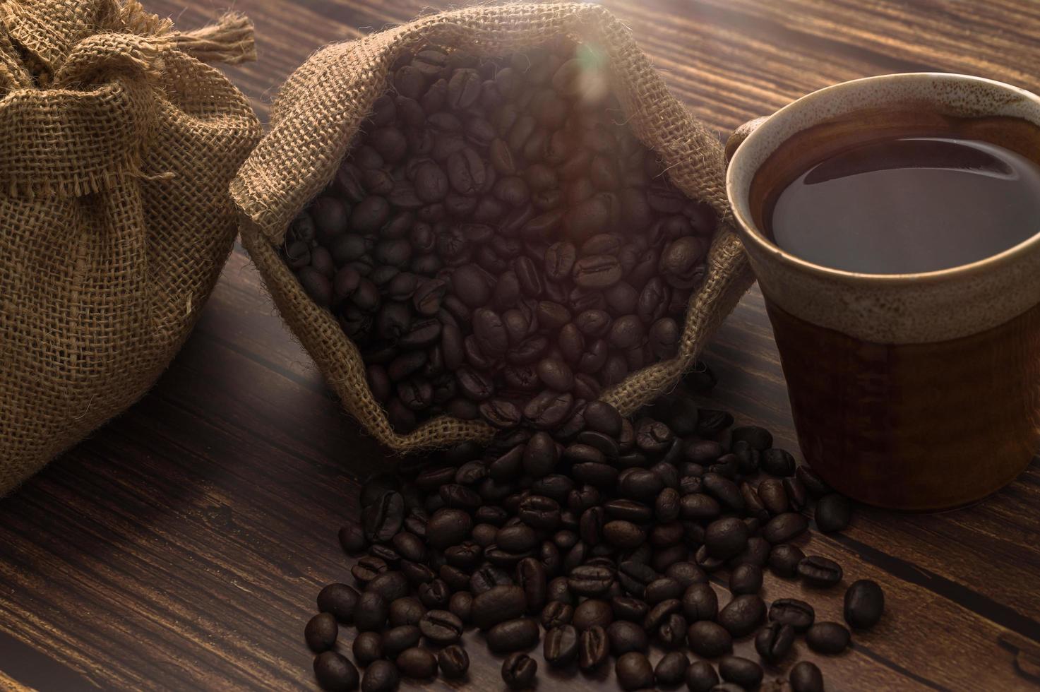 Coffee mug and coffee beans on the table photo