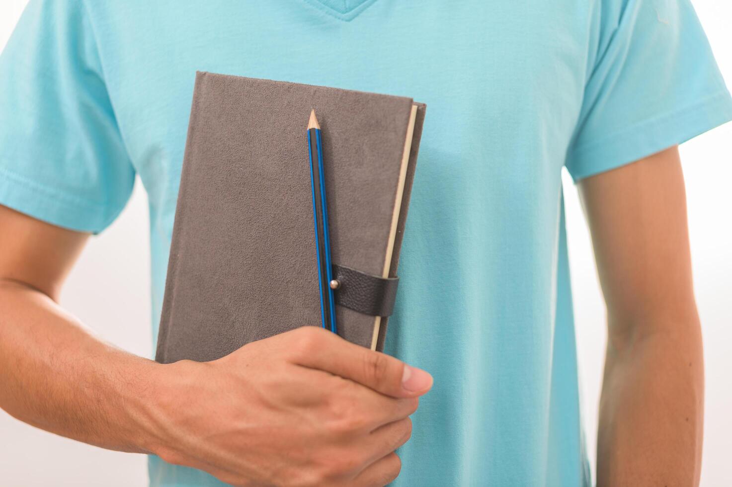 Men holding books and pencils photo