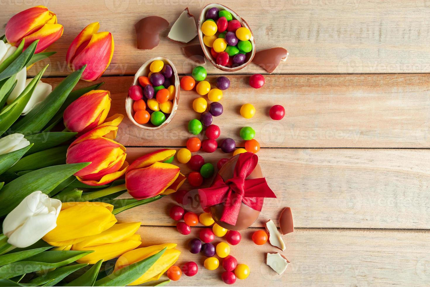 tulipanes multicolores y huevos de pascua de chocolate foto
