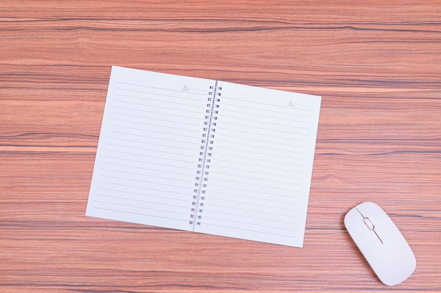 Notebook and mouse on the table photo