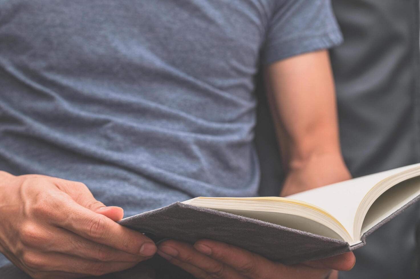 A man reading a notebook photo