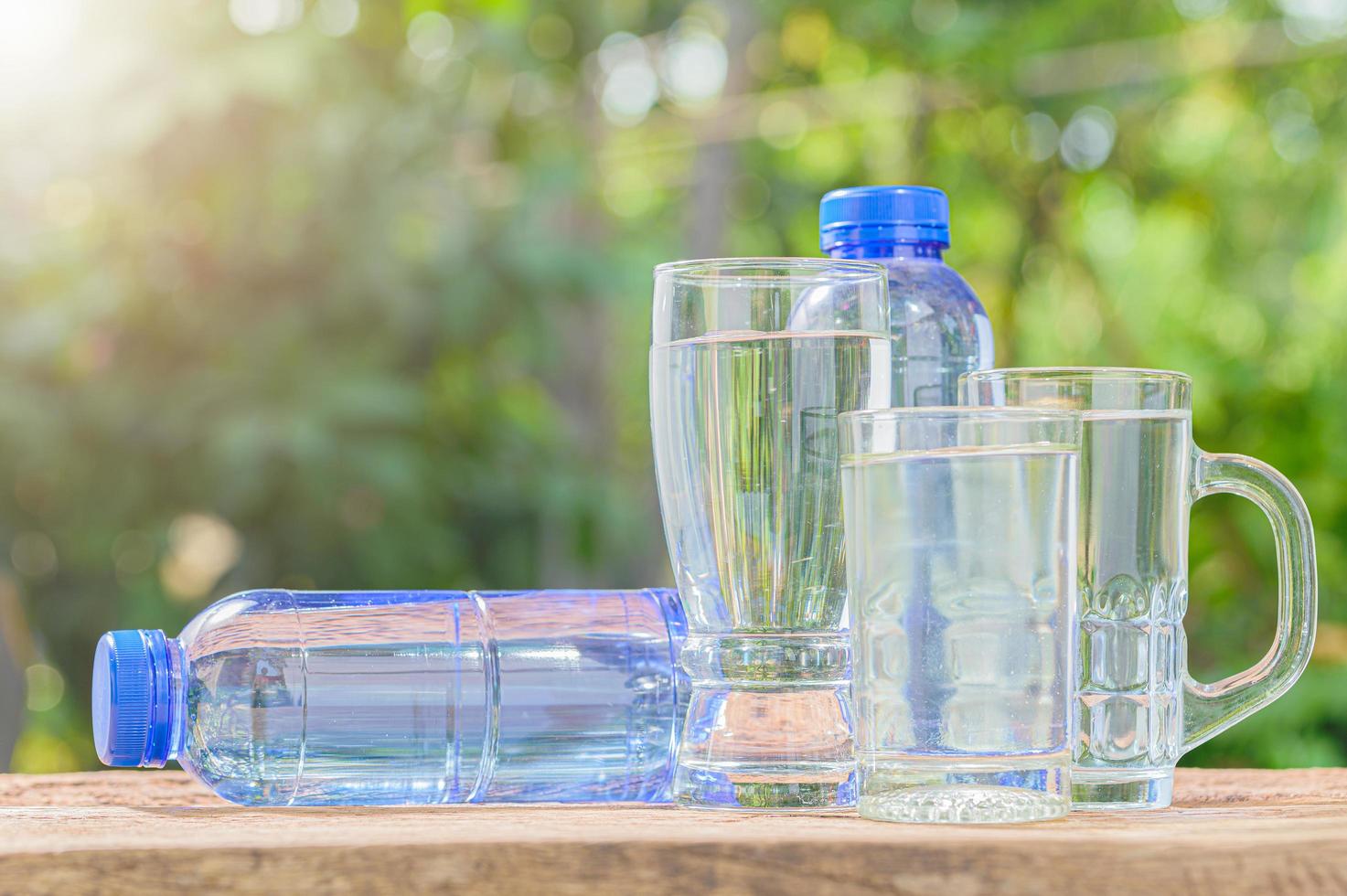 Bottles and classes of drinking water photo