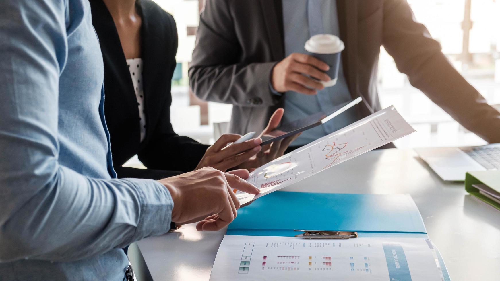 Business people having a meeting and discussing charts photo