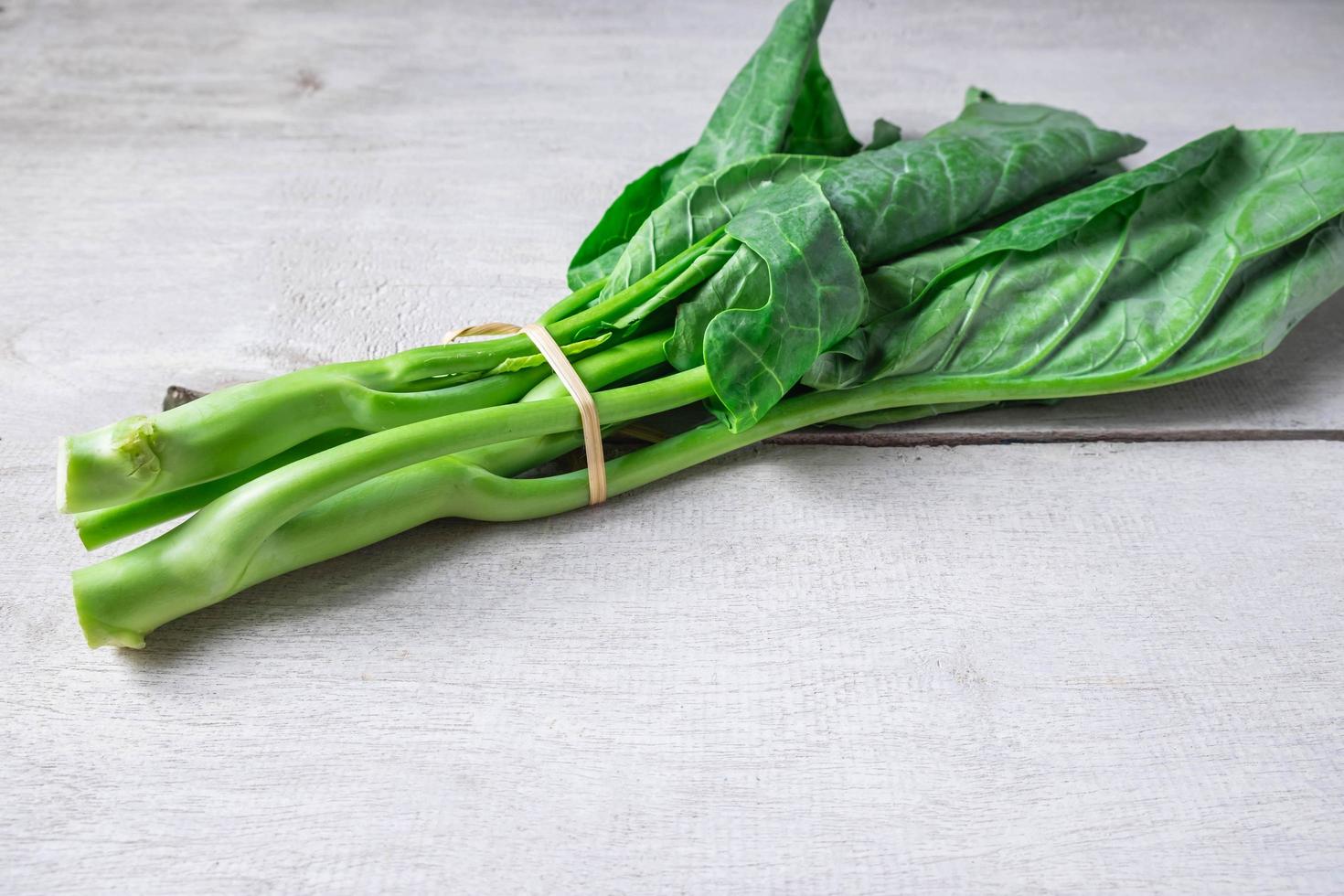 Chinese kale on a white table background photo