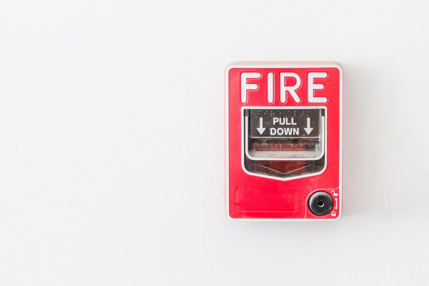 Fire alarm switch on white wall photo