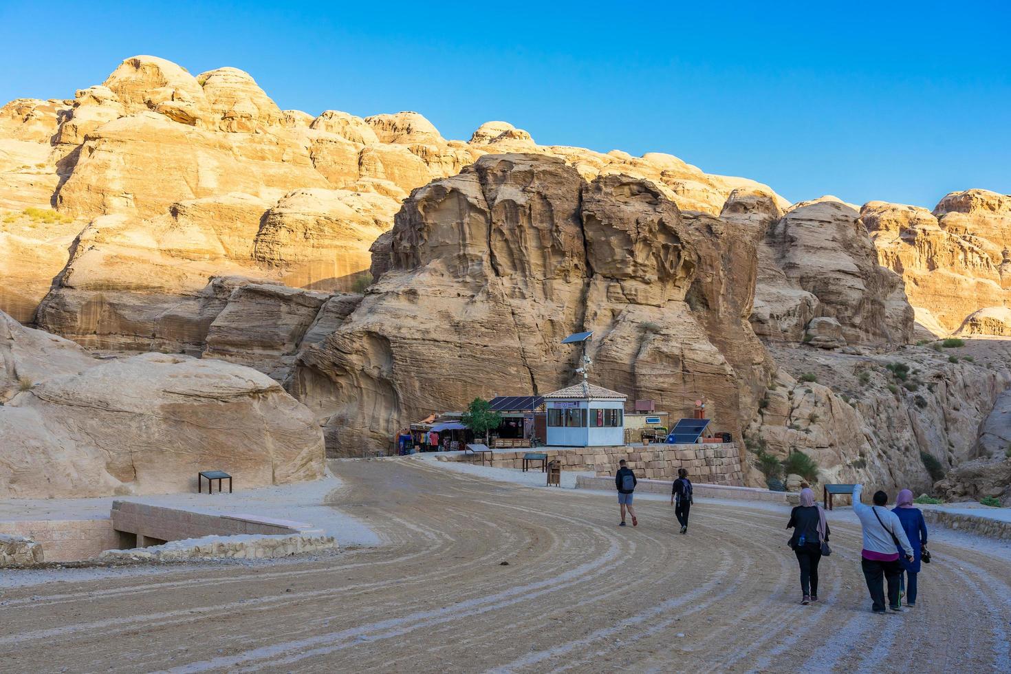 Tourists in narrow passage of rocks of Petra canyon in Jordan, 2018 photo