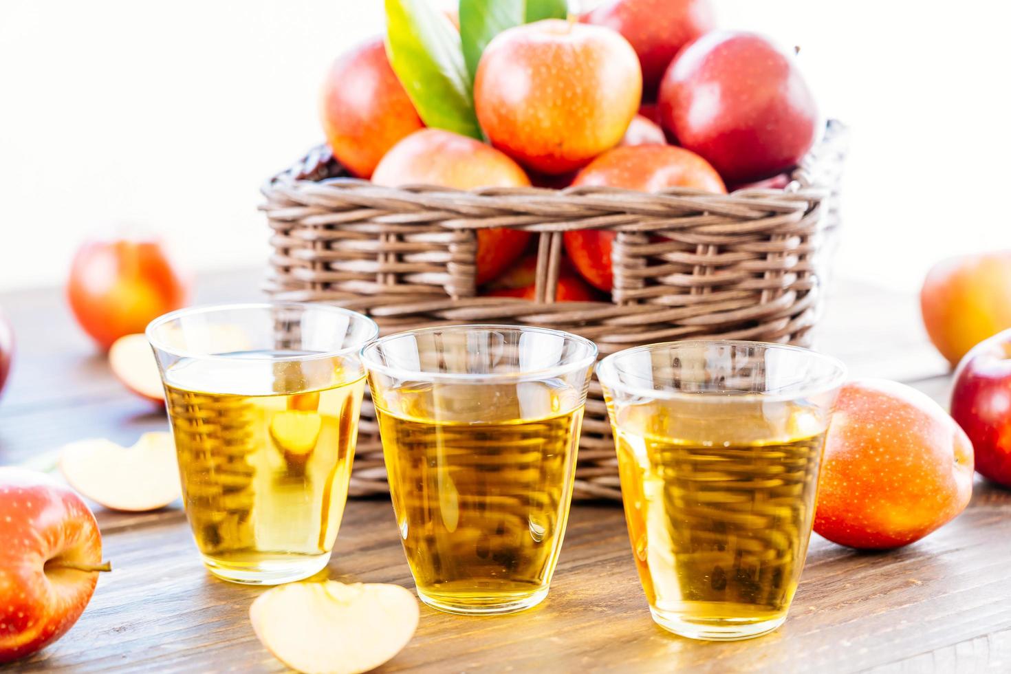 Apple juice in glasses and apples in the basket photo