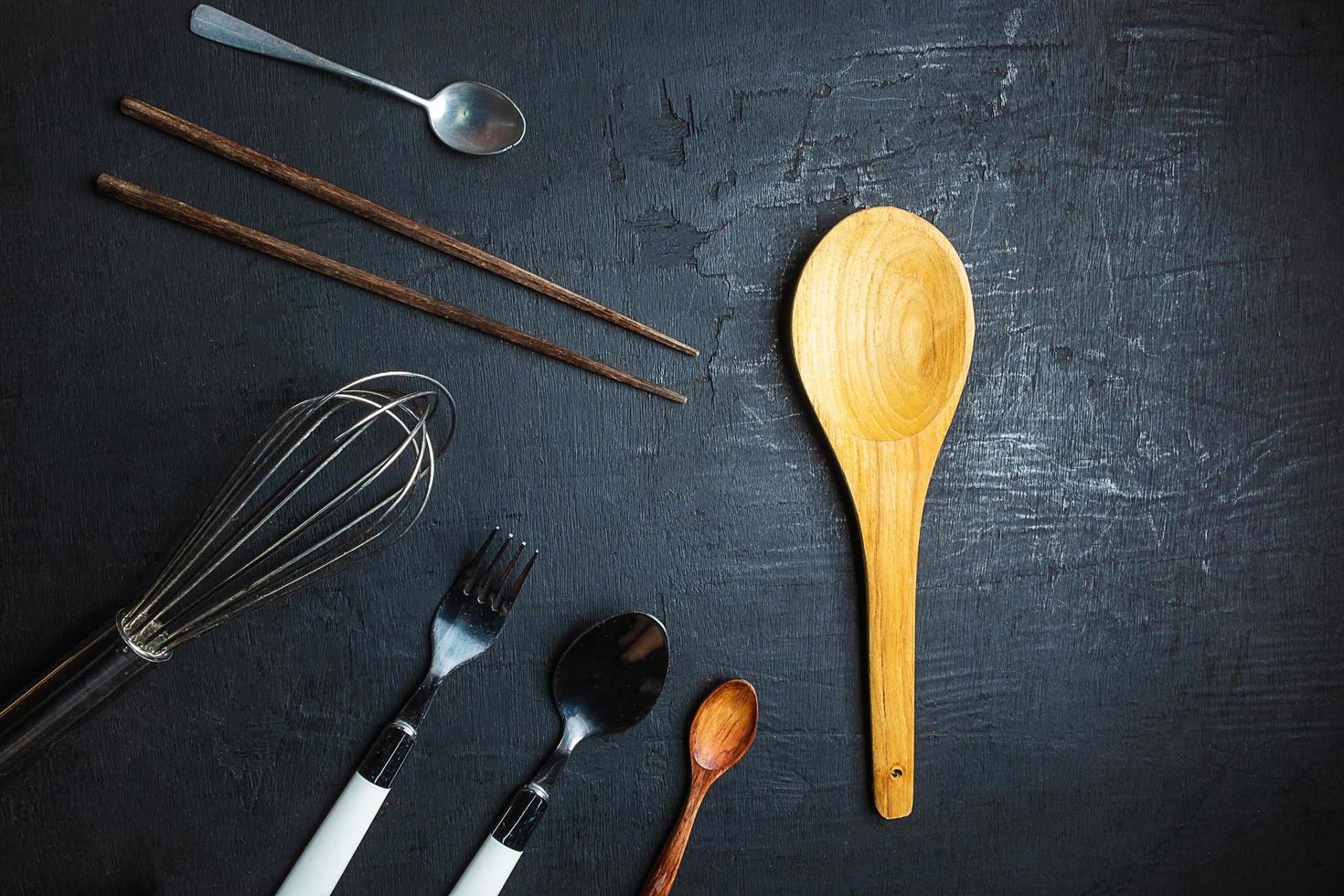 Kitchen utensils on black table background photo