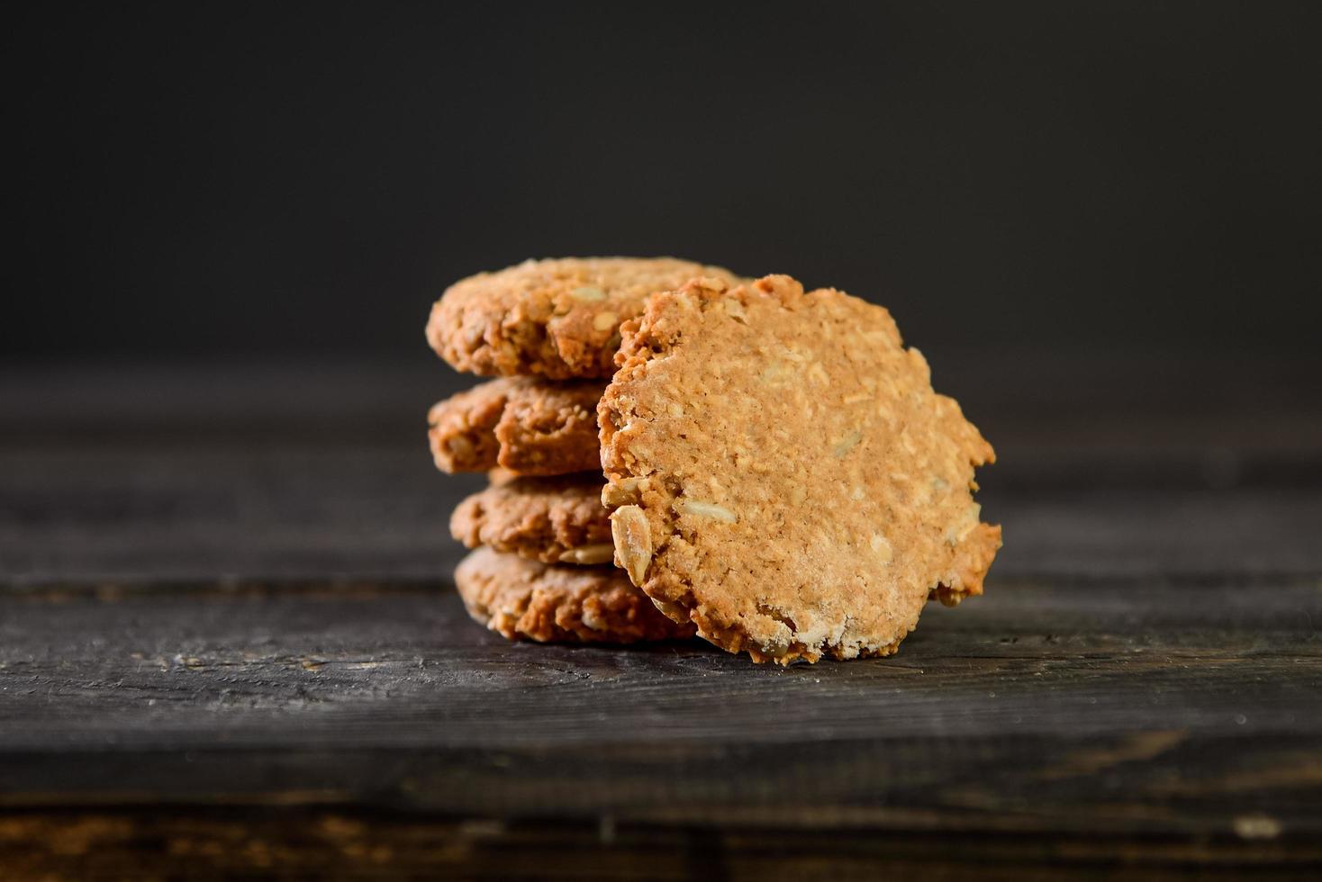 Pile of oat cookies on wooden table photo