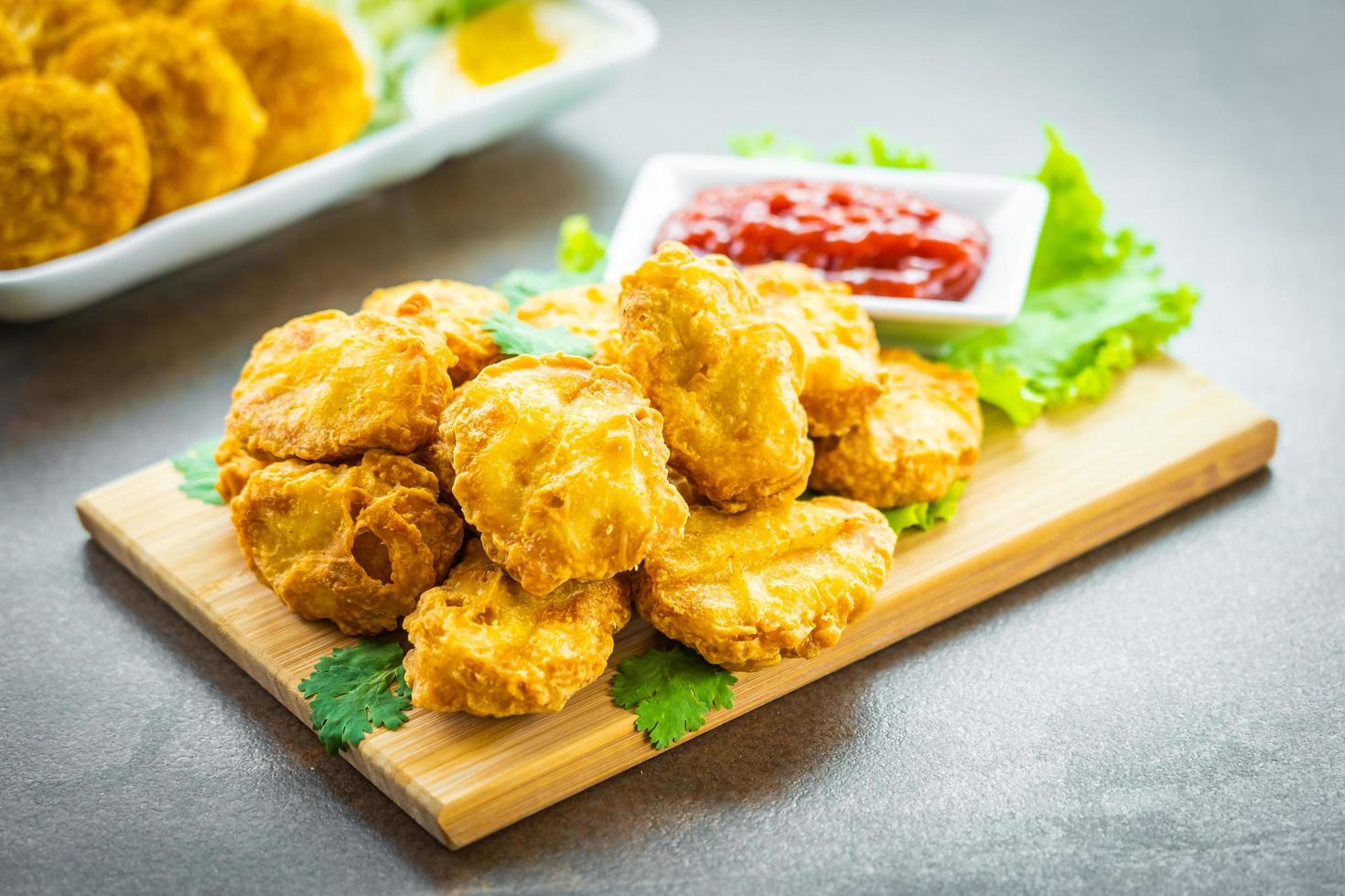 Deep fried chicken nuggets with ketchup photo