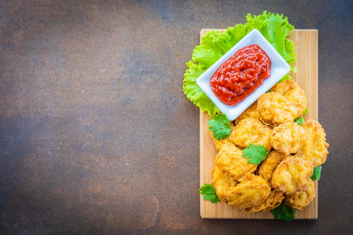 Deep fried chicken nuggets with ketchup photo