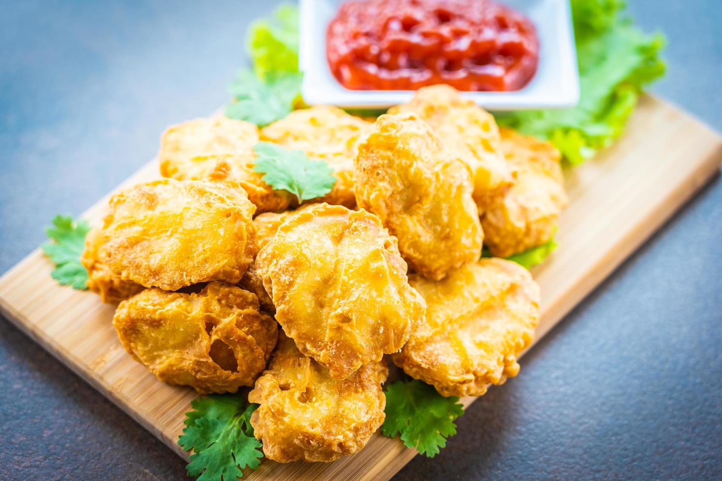 Deep fried chicken nuggets with ketchup photo