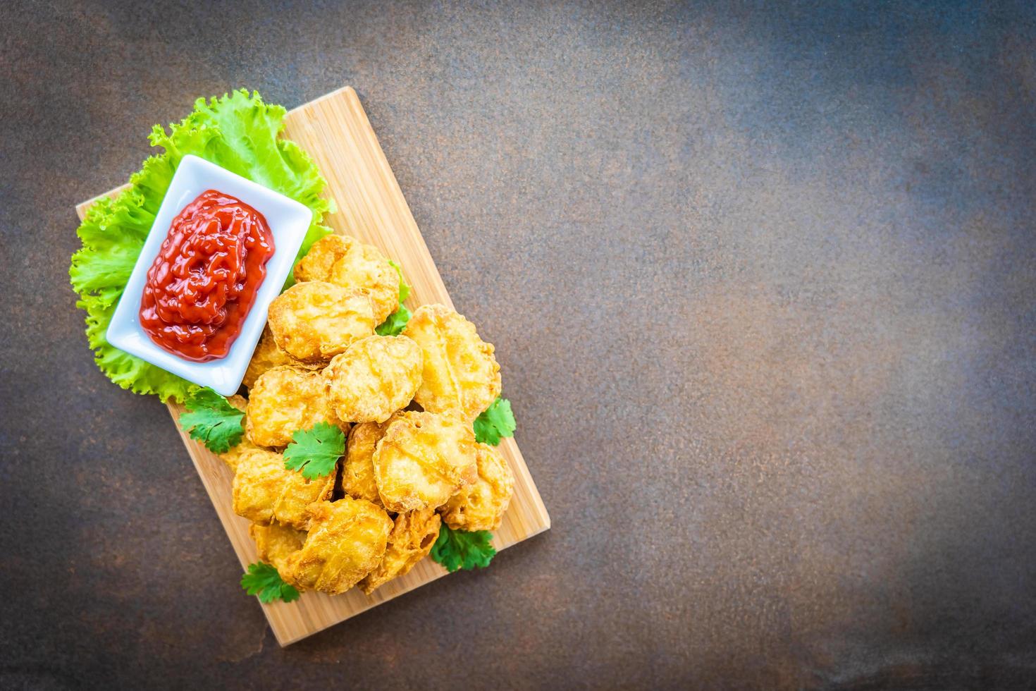 Deep fried chicken nuggets with ketchup photo