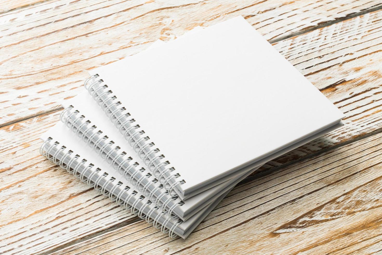 Blank notebook mock up on wooden background photo