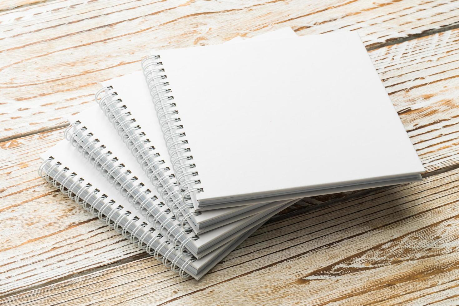 Blank notebook mock up on wooden background photo