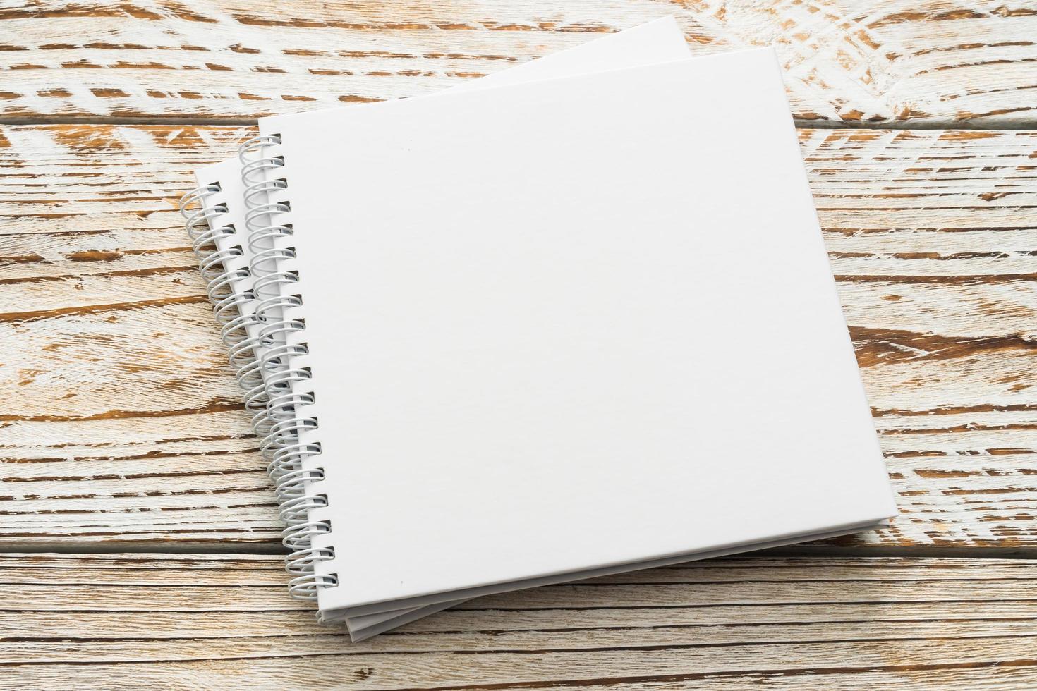 Blank notebook mock up on wooden background photo