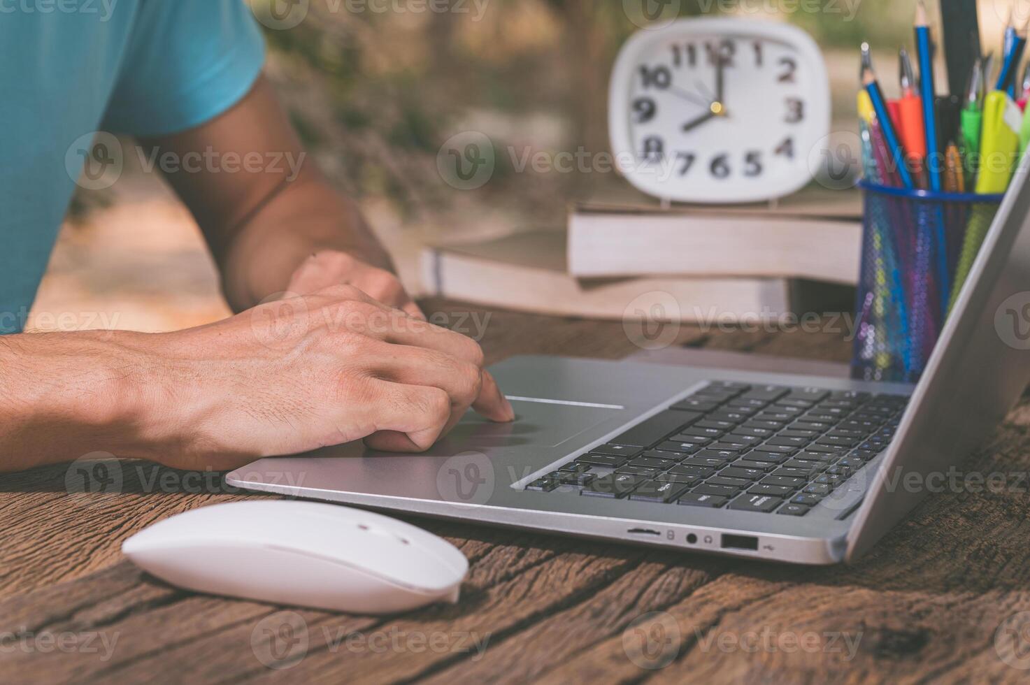 A person typing on a laptop computer photo