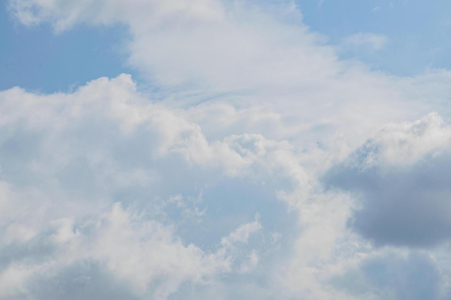 Sky clouds on blue background photo