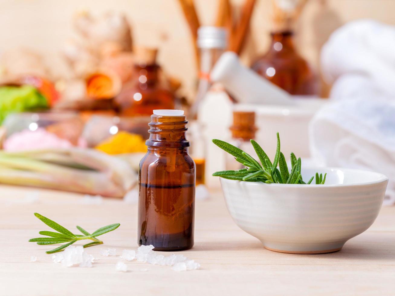 Rosemary essential oil bottle on a table photo