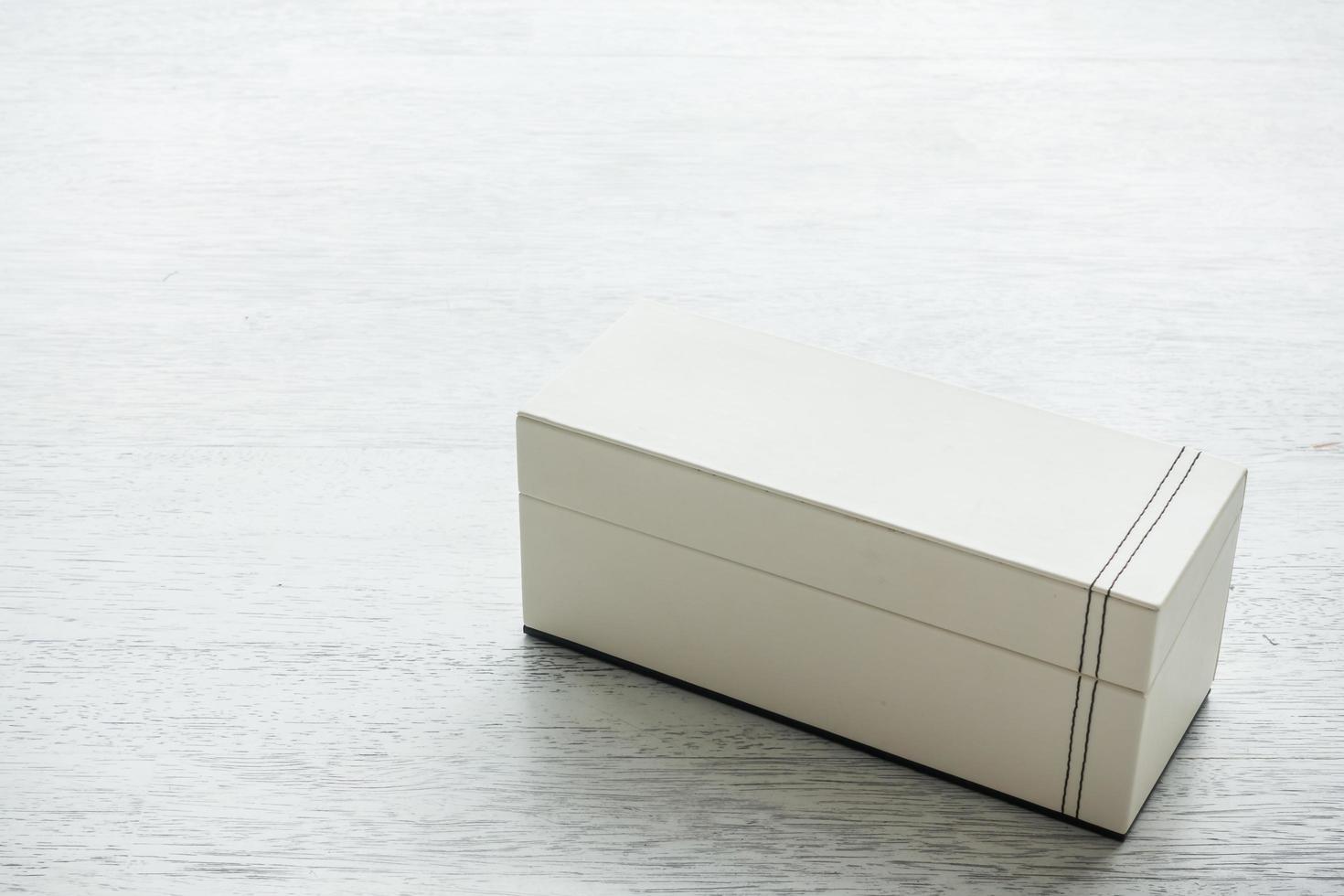 White leather box on wooden background photo