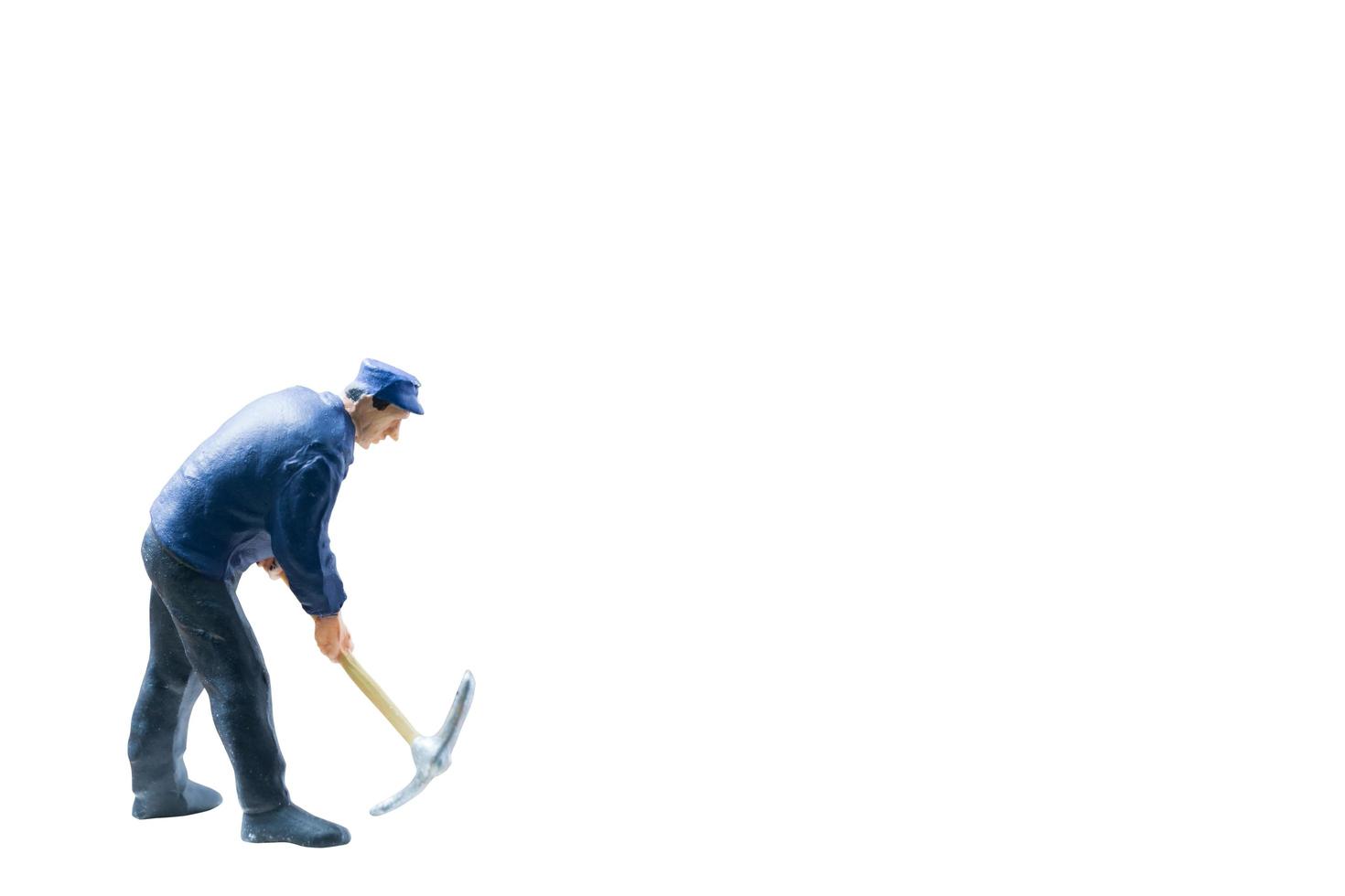 Miniature construction worker concept isolated on a white background photo