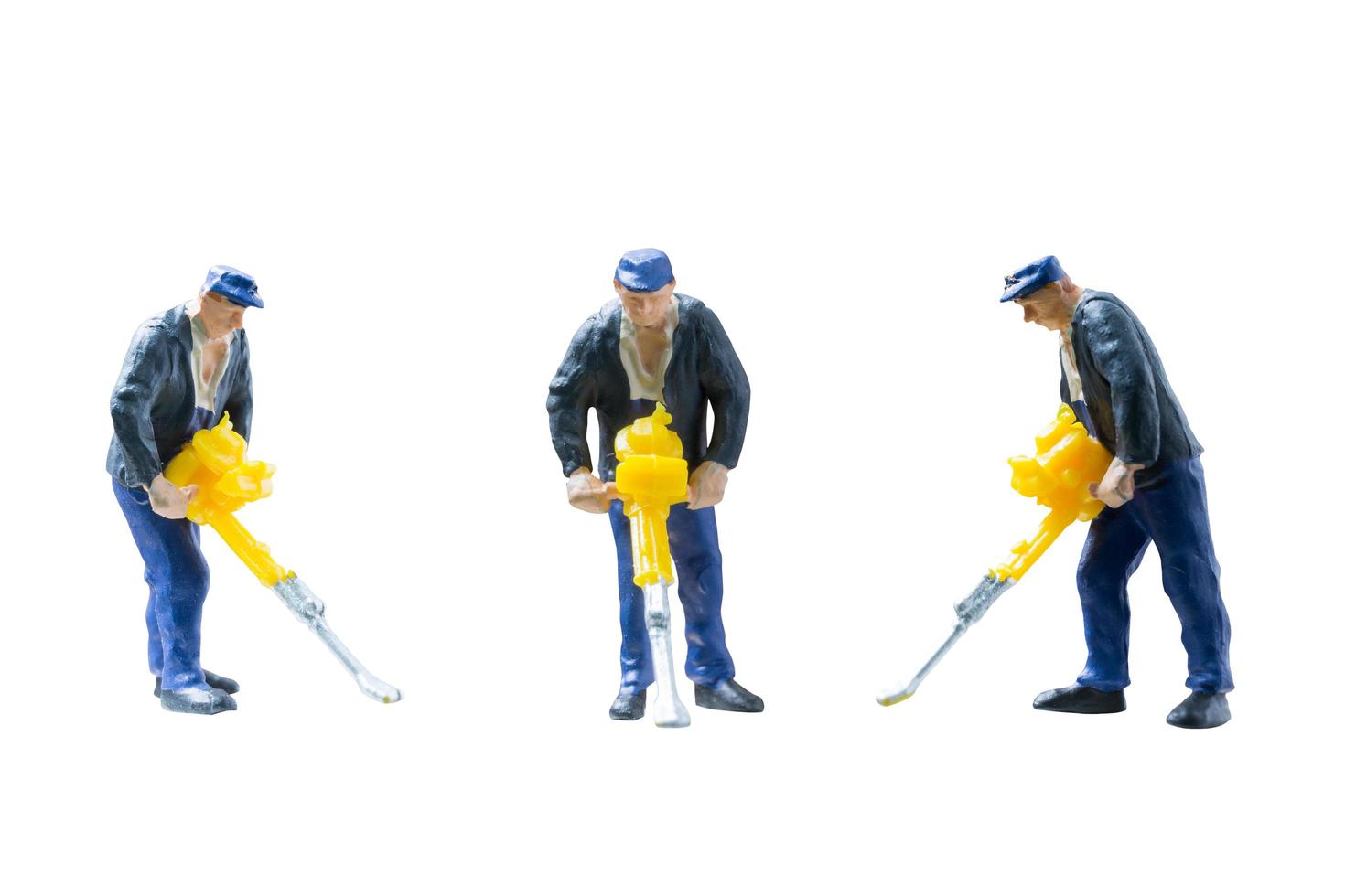 Miniature construction workers concept isolated on a white background photo