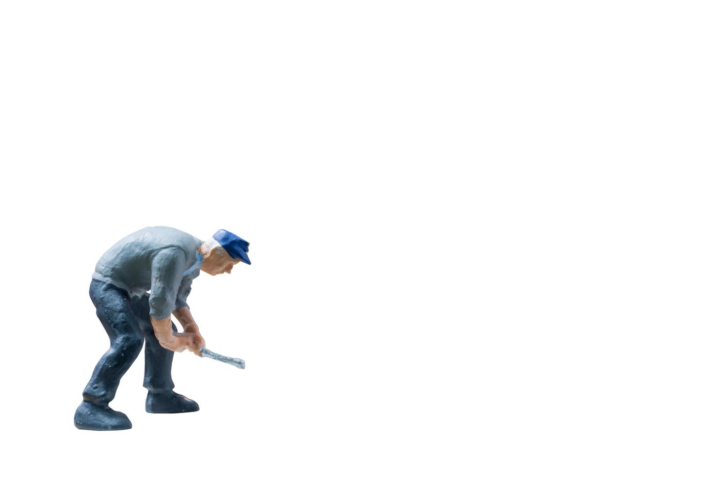 Miniature construction worker concept isolated on a white background photo