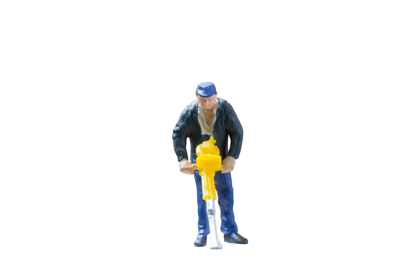Miniature construction worker concept isolated on a white background photo