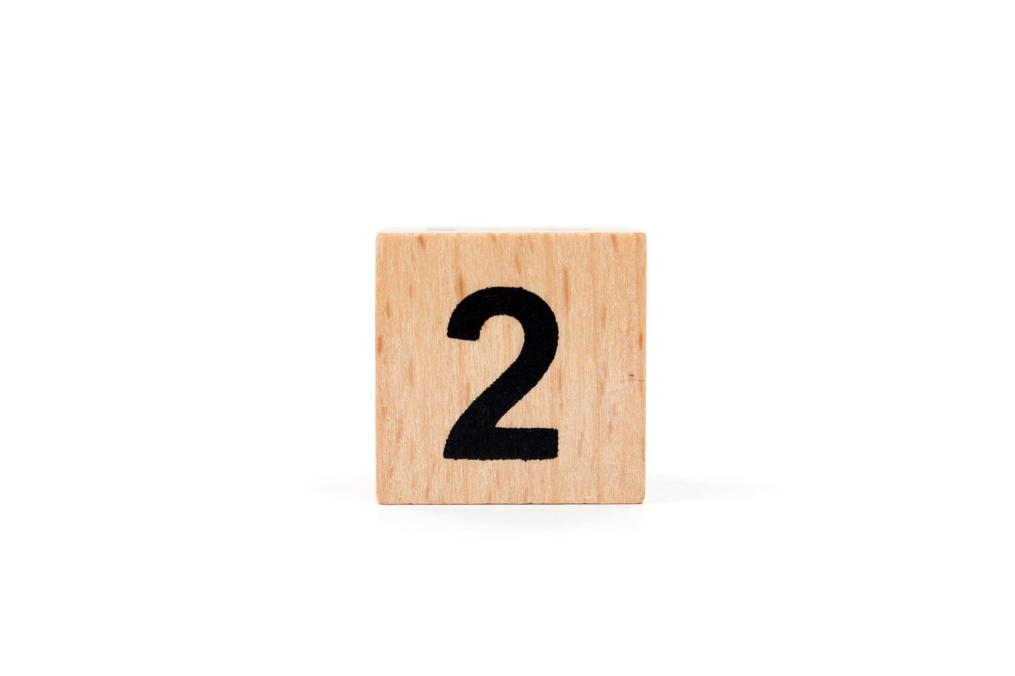 Wooden block number two on a white background photo