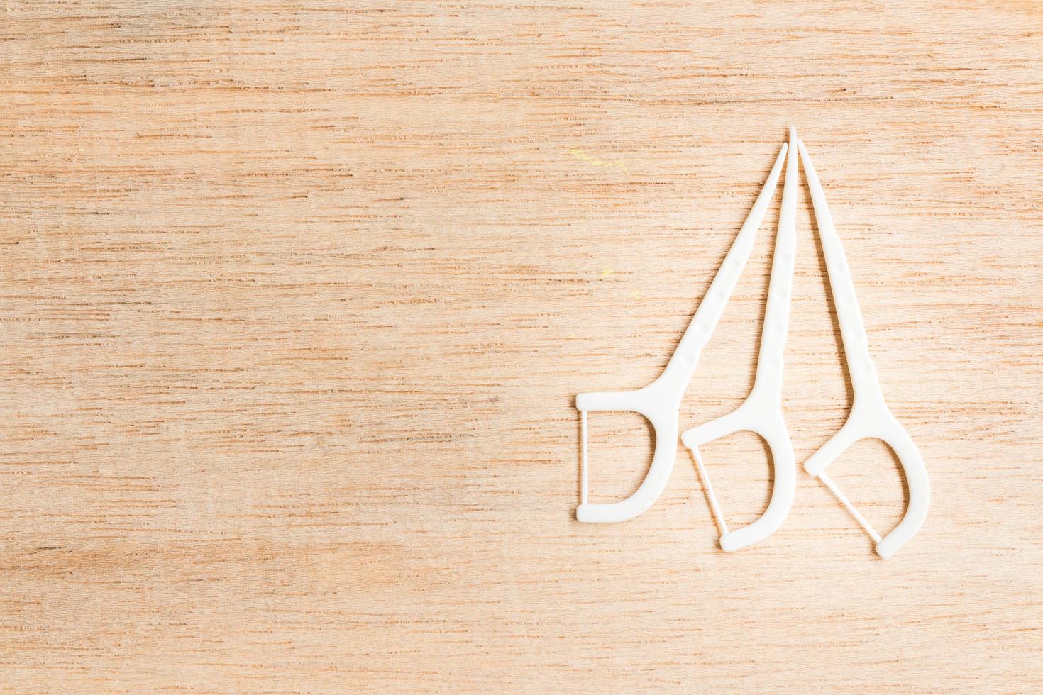Oral device dental flosser on a wooden background photo