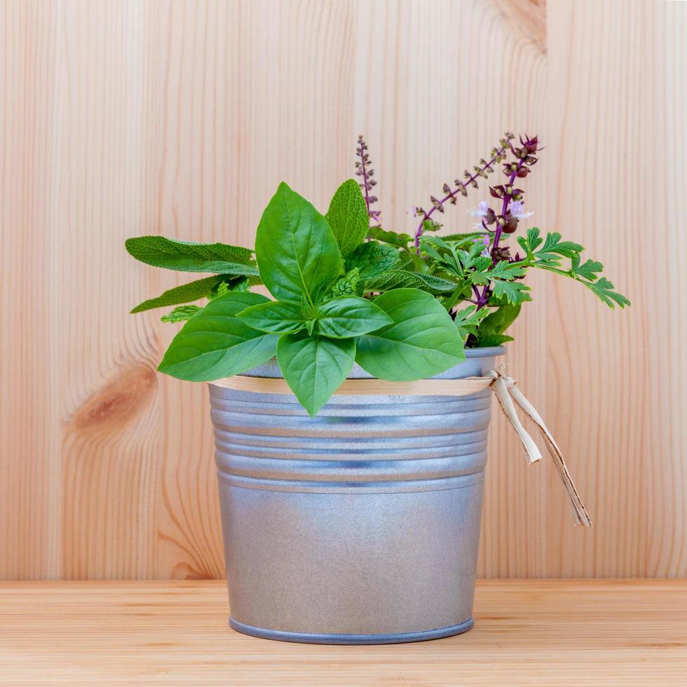 Bucket of herbs on wood photo