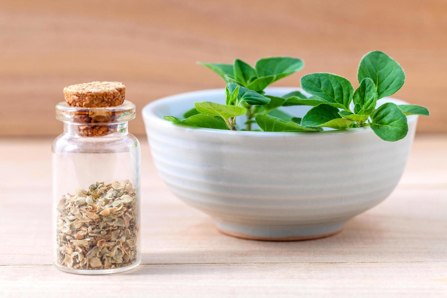 Bowl of fresh oregano with dried oregano photo