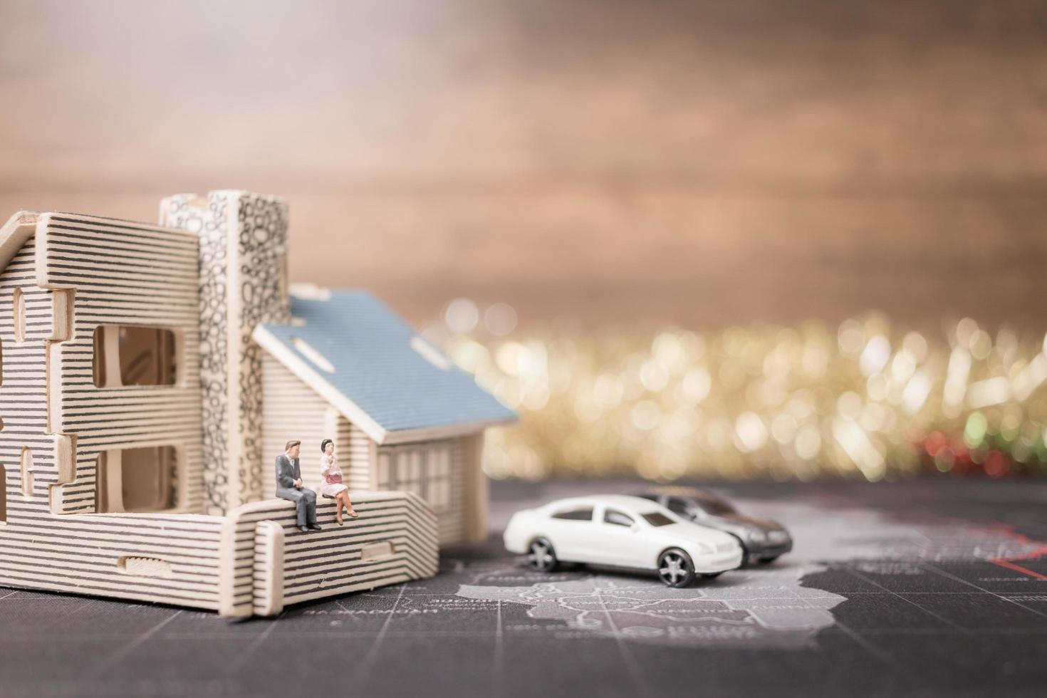 Miniature people sitting at home, investment and growth in business concept photo