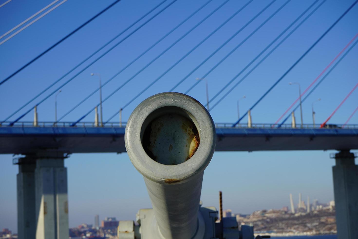 Landscape with a view of Voroshilov Battery and the Russky Bridge against a clear blue sky in Vladivostok, Russia photo