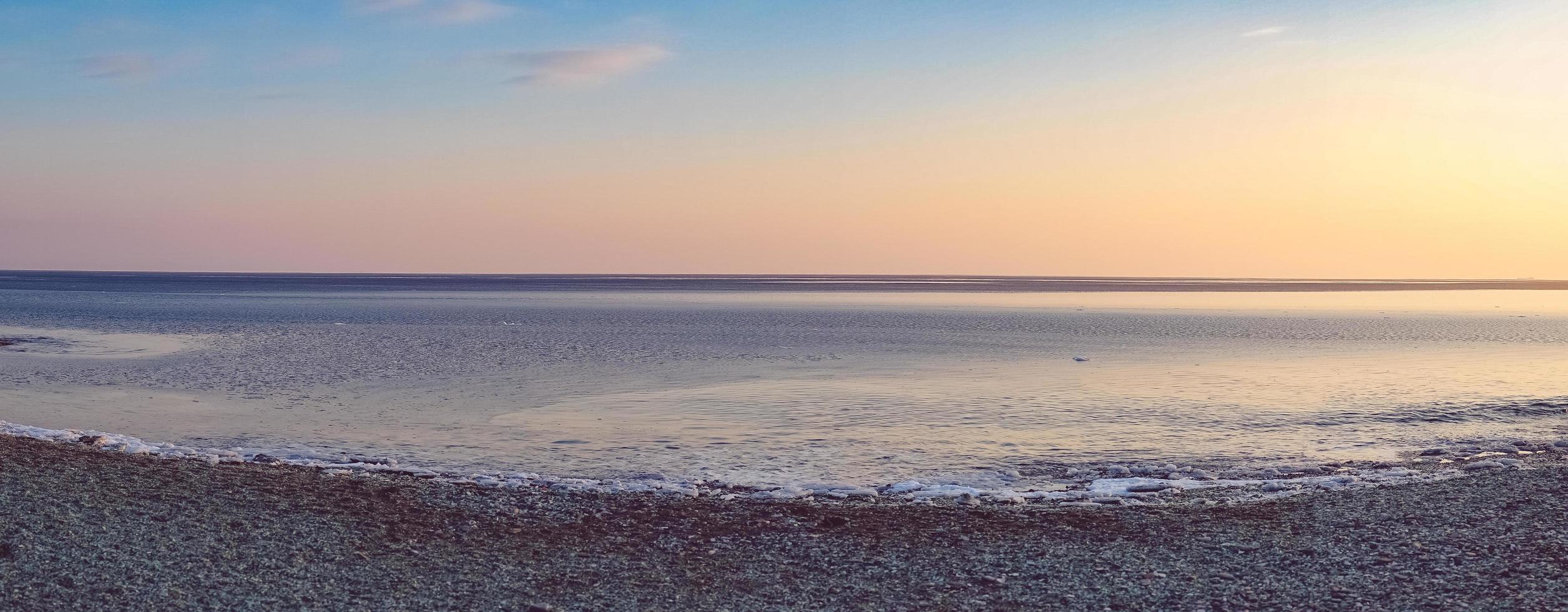 Panorama seascape of beach and colorful cloudy sky photo