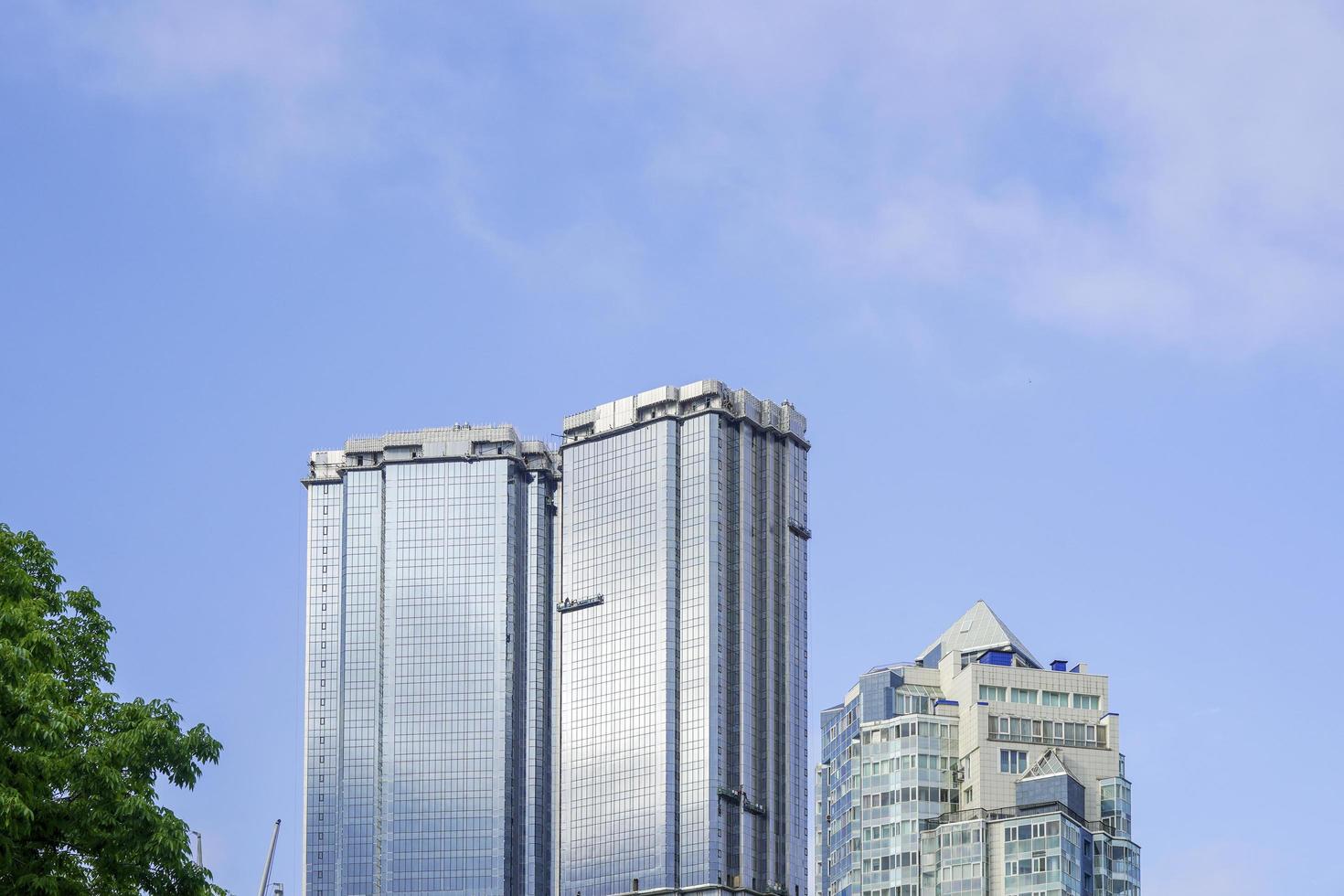 Urban landscape of tall buildings and cloudy blue sky in Vladivostok, Russia photo