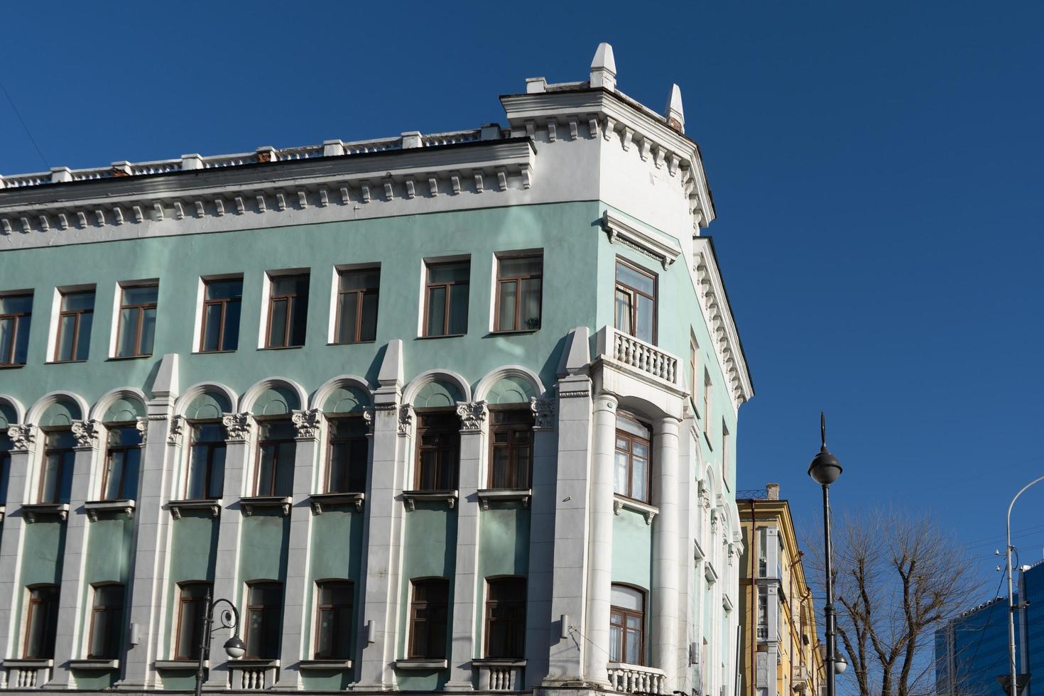 Urban landscape of tall buildings and cloudy blue sky in Vladivostok, Russia photo