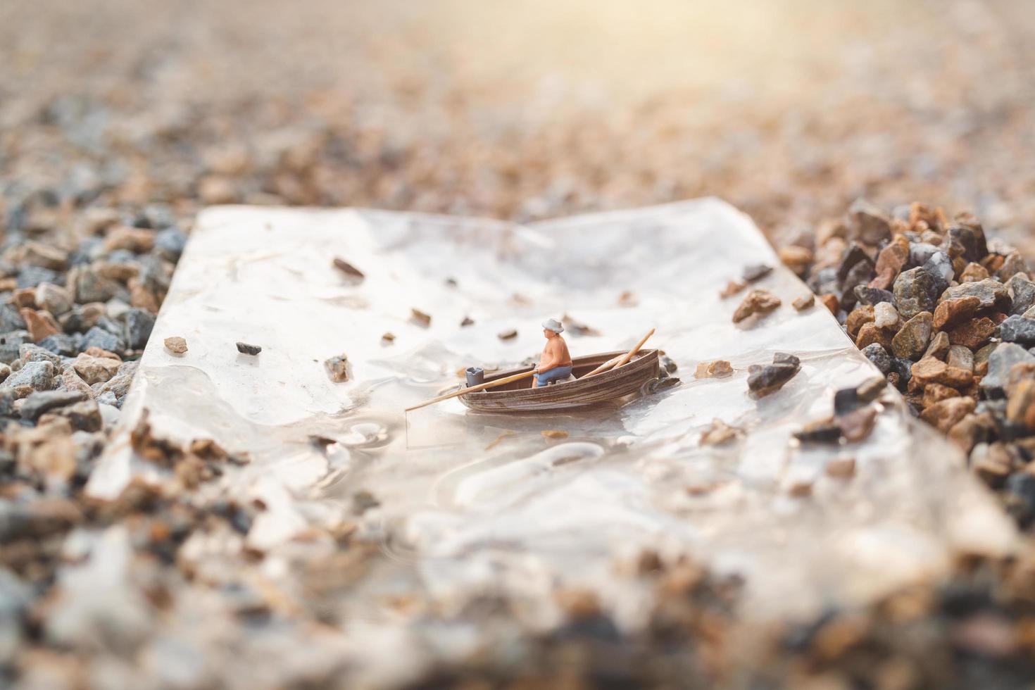 Miniature fisherman fishing on a boat photo