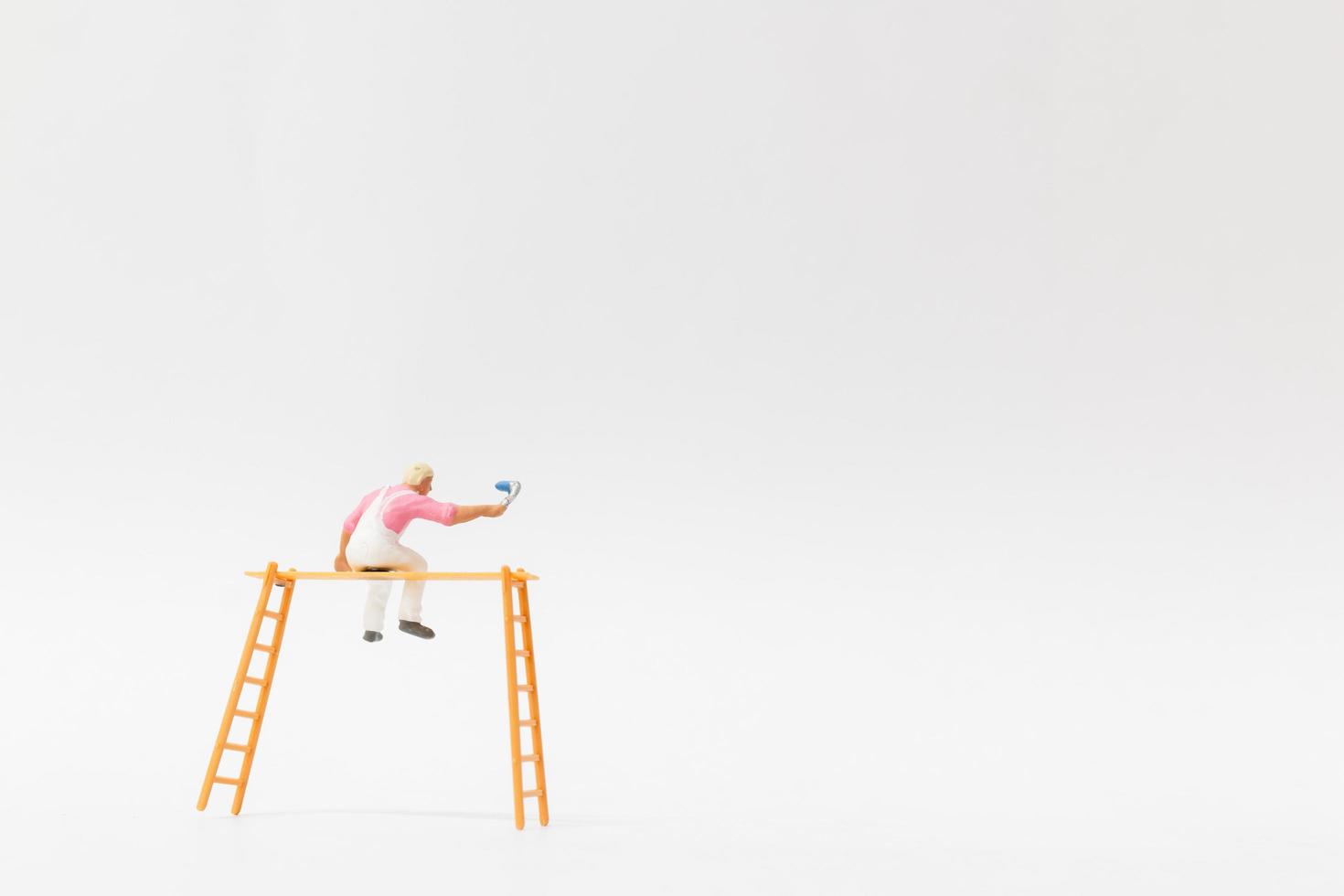 Miniature painter holding a brush on a white background photo