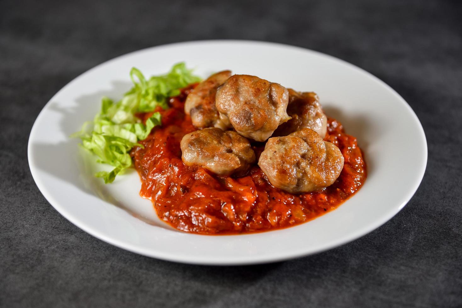Homemade chicken meatballs in tomato sauce photo