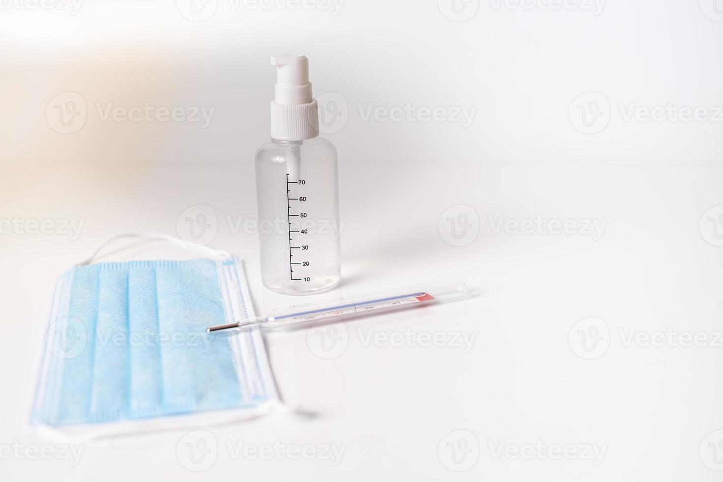 Surgical mask with thermometer and disinfectant gel photo