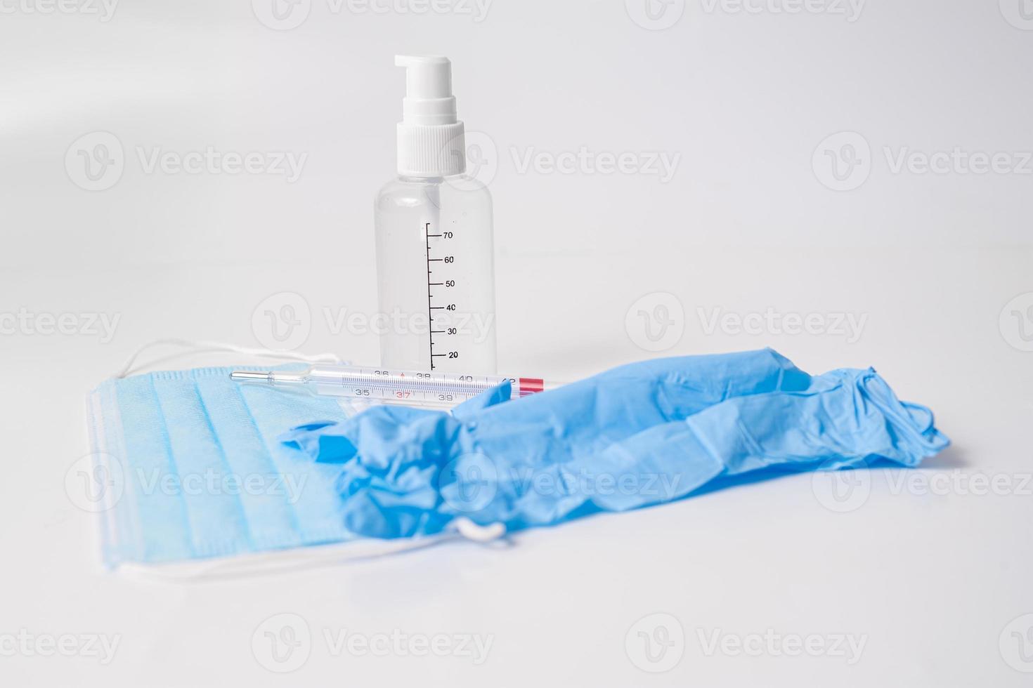 Surgical mask with gloves, thermometer and disinfectant gel photo