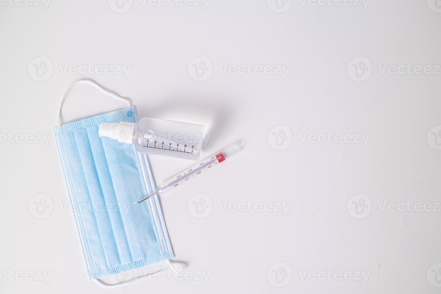 Surgical mask with thermometer and disinfectant gel photo