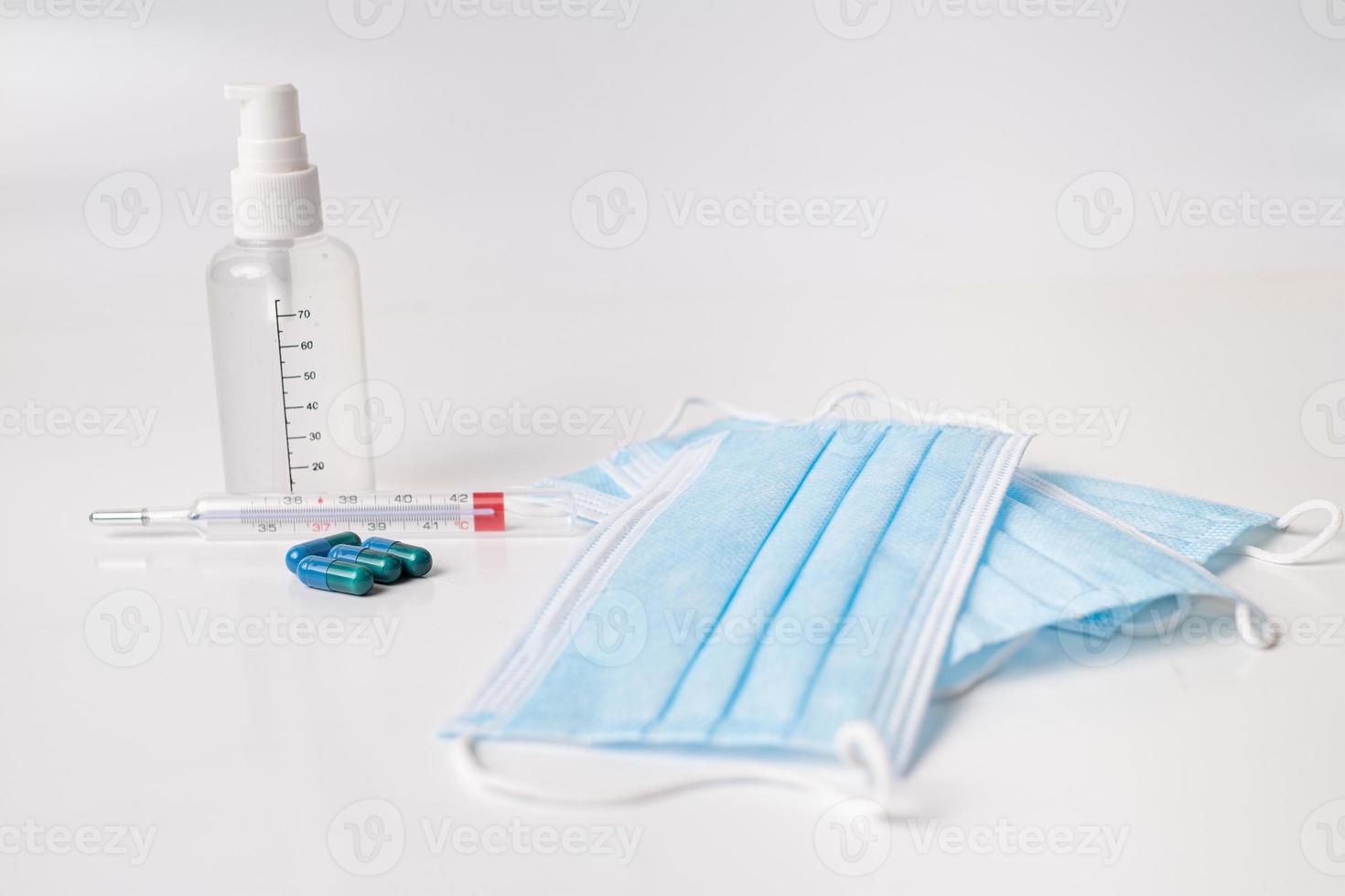 Surgical mask medicinal capsules and thermometer photo