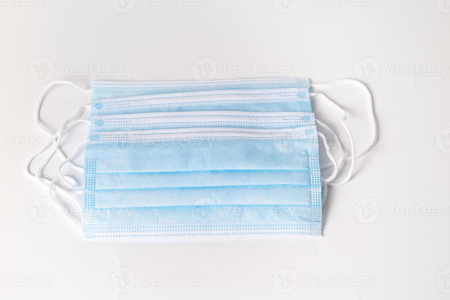 Several blue surgical masks photo