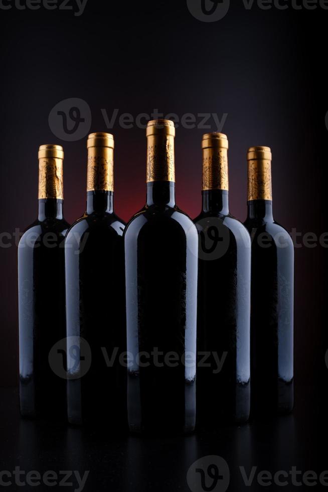 Wine bottles with black background and red photo